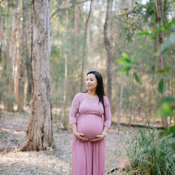 Pregnant woman performing a gentle yoga pose in a calm, serene environment.
